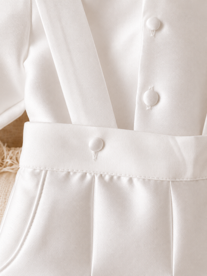 A timeless two piece set designed for baptisms, christenings and special occasions. Crafted in luxurious mikado, this classic ensemble pairs a beautifully tailored long sleeve shirt with coordinating tailored trousers and suspenders. 