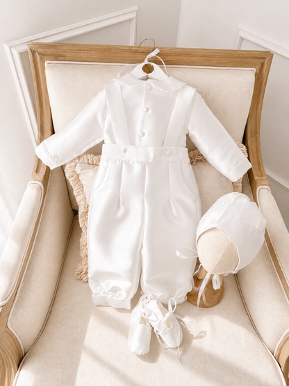 A timeless two piece set designed for baptisms, christenings and special occasions. Crafted in luxurious mikado, this classic ensemble pairs a beautifully tailored long sleeve shirt with coordinating tailored trousers and suspenders. 