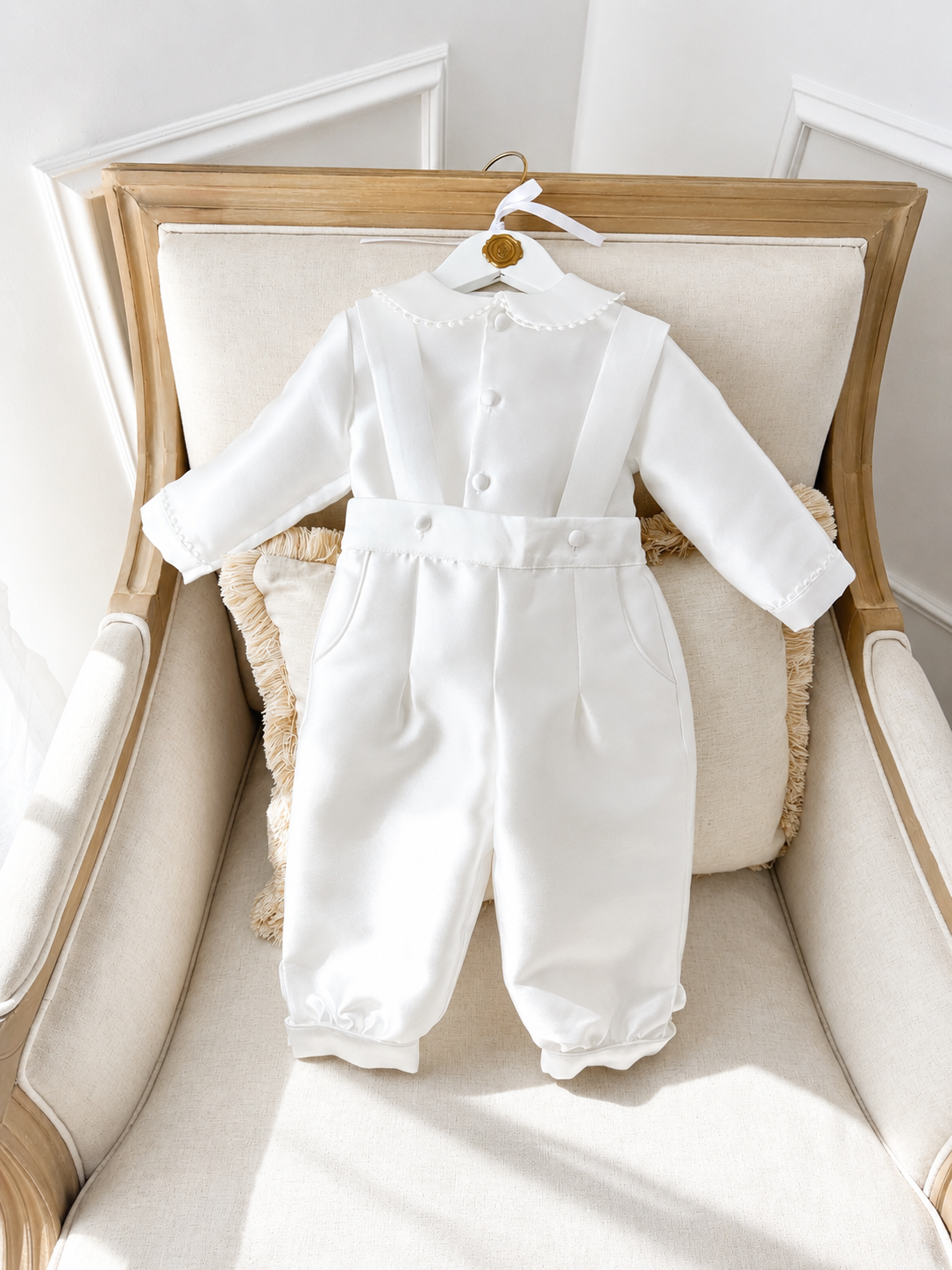 A timeless two piece set designed for baptisms, christenings and special occasions. Crafted in luxurious mikado, this classic ensemble pairs a beautifully tailored long sleeve shirt with coordinating tailored trousers and suspenders. 