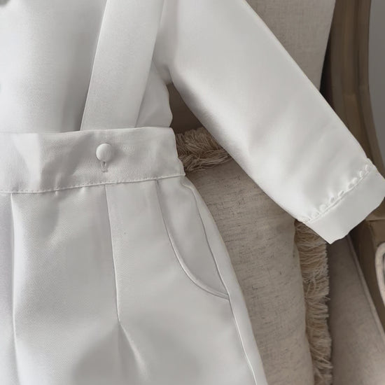 A timeless two piece set designed for baptisms, christenings and special occasions. Crafted in luxurious mikado, this classic ensemble pairs a beautifully tailored long sleeve shirt with coordinating tailored trousers and suspenders. 