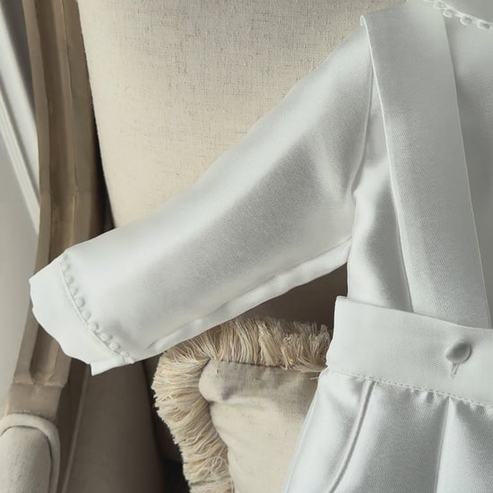 A timeless two piece set designed for baptisms, christenings and special occasions. Crafted in luxurious mikado, this classic ensemble pairs a beautifully tailored long sleeve shirt with coordinating tailored trousers and suspenders. 